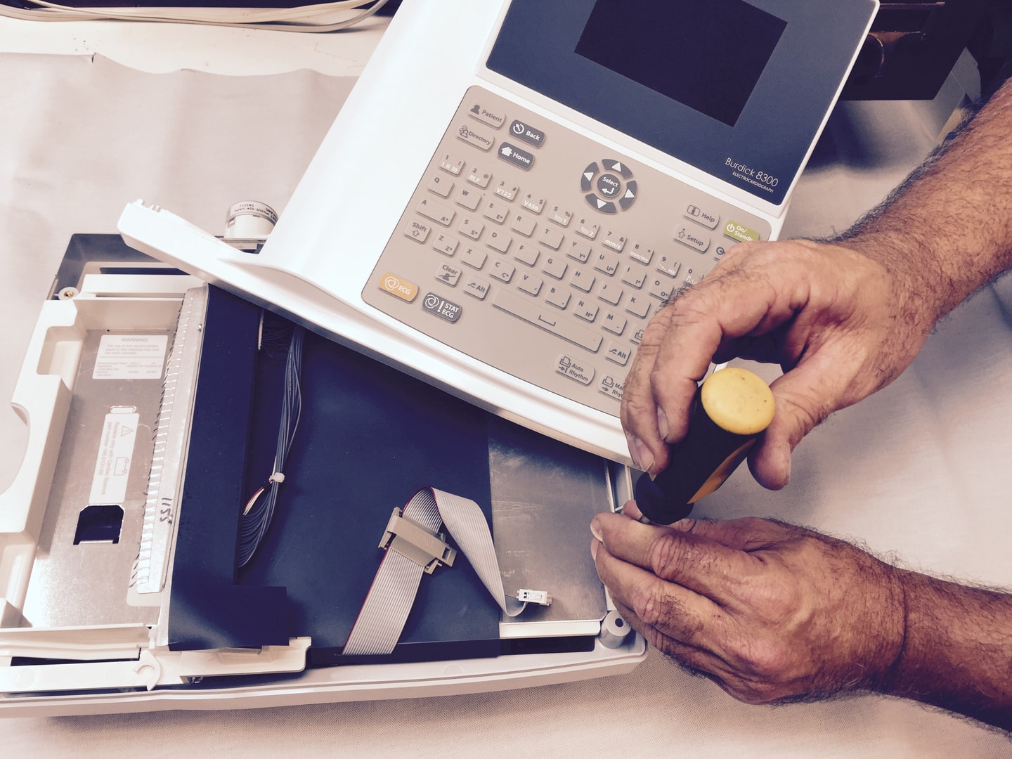 Medical equipment repair technician at work
